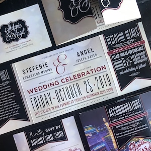May include: Wedding invitation suite with black and white design and red accents. The invitation features the couple's names, wedding date, and location. The RSVP card includes the date to RSVP. The reception details card includes information about the cocktail hour, dinner, and dancing. The accommodations card features a photo of the Las Vegas skyline and the hotel name.