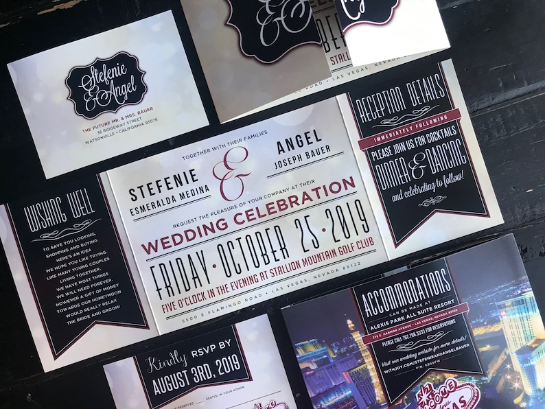 May include: Wedding invitation suite with black and white design and red accents. The invitation features the couple's names, wedding date, and location. The RSVP card includes the date to RSVP. The reception details card includes information about the cocktail hour, dinner, and dancing. The accommodations card features a photo of the Las Vegas skyline and the hotel name.