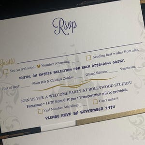 May include: White RSVP card with gold and purple accents. The card includes fill-in-the-blank sections for guest names, meal selections, and attendance confirmation. The text includes "Guests", "Rsvp", and "Welcome Party at Hollywood Studios!"