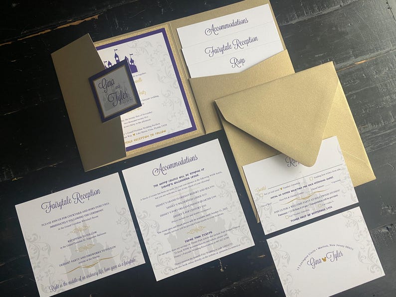 May include: A collection of gold and purple wedding invitations. The invitation suite includes an invitation, RSVP card, accommodations card, and reception card. The invitation features a castle graphic and the names "Gina & Tyler".