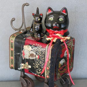 Assemblage black cat mother and kitten sculpture, Kichi & Atsuko.  Kitten is riding atop mother.  Asian tea tin body and castor feet.