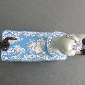 Cat assemblage, Isobel. Porcelain cat head, blue and white tin, industrial wood bobbins, castors, coat hook and rhinestone jewelry. image 7