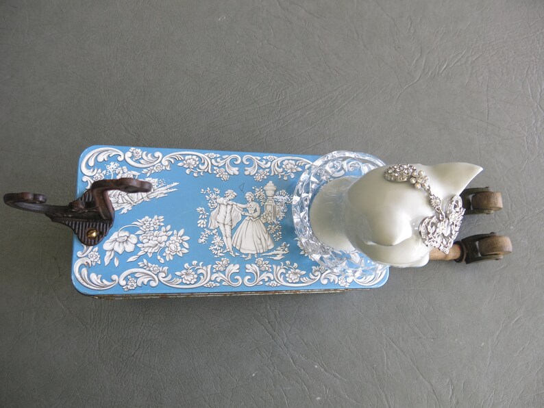 Cat assemblage, Isobel. Porcelain cat head, blue and white tin, industrial wood bobbins, castors, coat hook and rhinestone jewelry. image 7