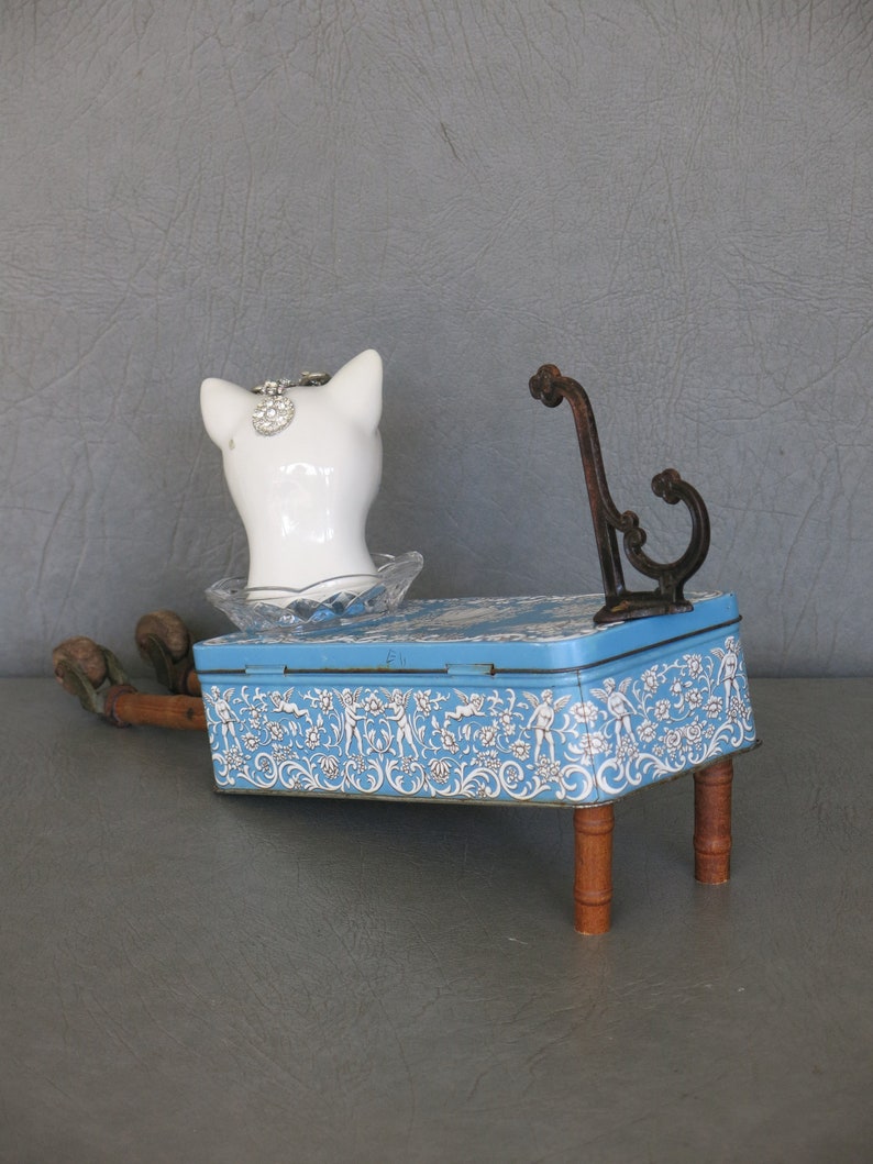 Cat assemblage, Isobel. Porcelain cat head, blue and white tin, industrial wood bobbins, castors, coat hook and rhinestone jewelry. image 6