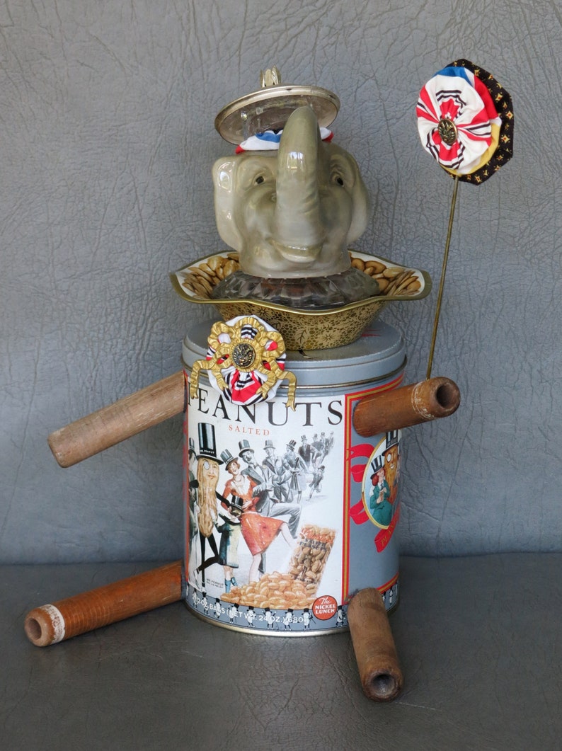 One-of-a-kind assemblage elephant, Peanut. Porcelain head, Planter's Peanuts tin body, bobbin legs, crystal and brass embellishments. image 3