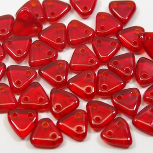 May include: A selection of translucent red triangular beads. Each bead features two holes for threading. The beads are a vivid red and seem to be made of glass or a similar material. Suitable for jewellery making.