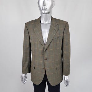 May include: A brown and green checked blazer with a three-button fastening.