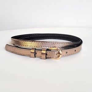Gold leather belt, made of natural soft leather. Women's waist skinny belt