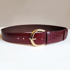 Burgundy croc leather belt with moon buckle. 2 inch wide croc pattern waist belt