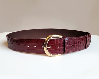 Burgundy croc leather belt with moon buckle. 2 inch wide croc pattern waist belt