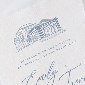 May include: A light-colored wedding invitation with a detailed blue line drawing of a modern house. The text reads "Together with our families, we invite you to the wedding of Emily + Trevor."