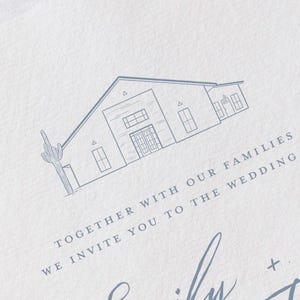 May include: A wedding invitation with a light blue illustration of a building and a cactus. The text reads "Together with our families, we invite you to the wedding of Emily + Trevor" in a delicate script font.
