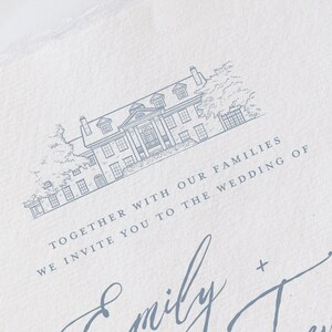 May include: A light blue wedding invitation with a detailed illustration of a stately home at the top. The invitation includes the names "Emily + Trevor" in elegant script, and the text "Together with our families, we invite you to the wedding of."