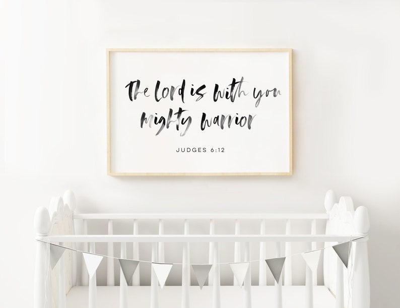 May include: A framed print with a white background and black text that reads "The Lord is with you mighty warrior" with the scripture reference "Judges 6:12" below the text.