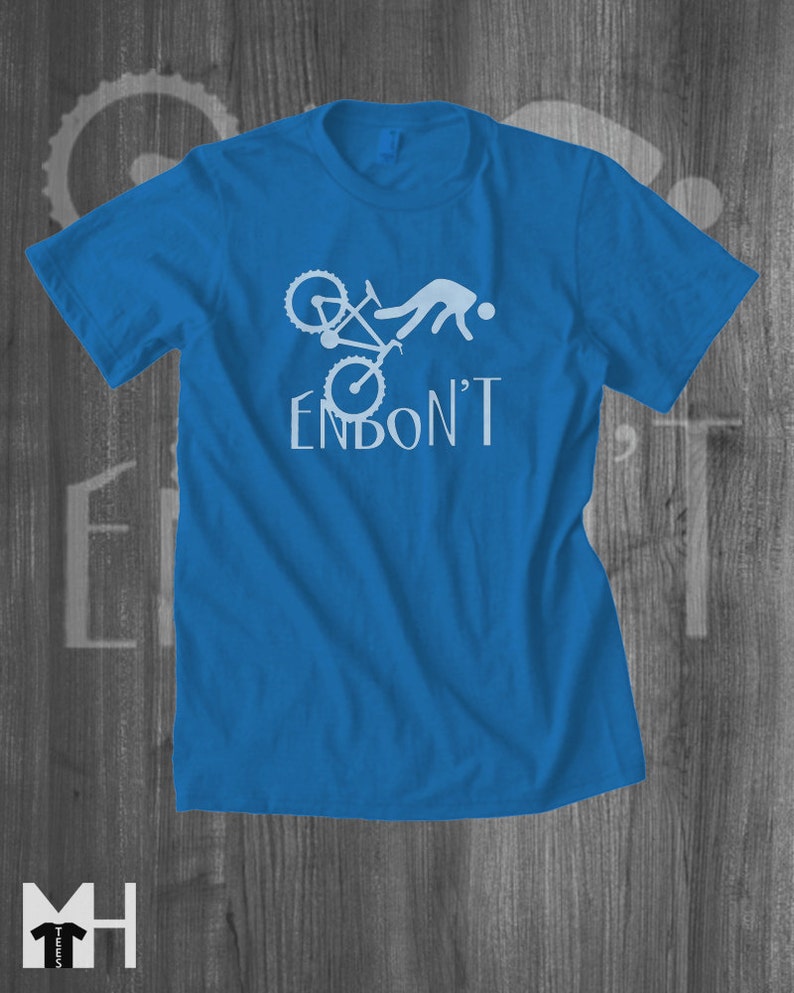 May include: A royal blue t-shirt with a white graphic of a person falling off a bicycle with the text "ENBON'T".