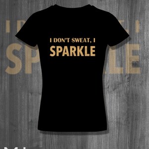 May include: Black t-shirt with the text "I don't sweat, I sparkle" in gold lettering.