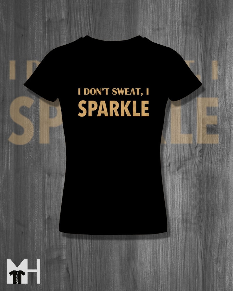 May include: Black t-shirt with the text "I don't sweat, I sparkle" in gold lettering.