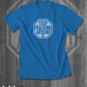 May include: A royal blue t-shirt with a white stop sign graphic that says "Stop Fracking Around" with a skull symbol.