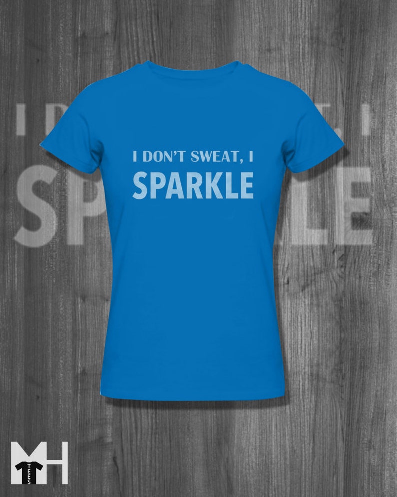 May include: A bright blue t-shirt with the text "I don't sweat, I sparkle" in white.