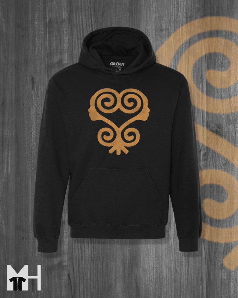 May include: Black hooded sweatshirt with a gold Adinkra symbol on the front. The symbol is a heart shape with two stylized faces inside.