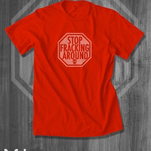 May include: Red t-shirt with a white stop sign graphic that says "Stop Fracking Around".