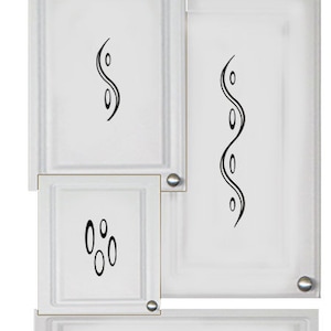 May include: White cabinet doors with decorative black swirl designs. The cabinet doors are arranged vertically with a smaller drawer below. The drawer has a black swirl design on the front.