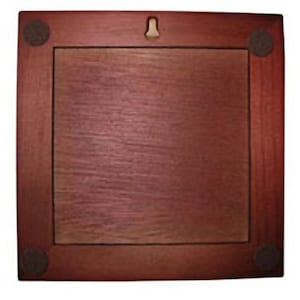 May include: A dark red wooden picture frame with a light brown mat and four black felt pads on the corners. The frame has a metal hanger on the back.