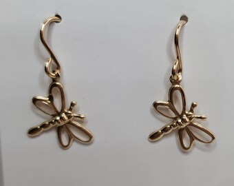 May include: Gold dragonfly earrings on a white card with the text "Refined Designs Handmade Jewelry" and contact information for the artist.