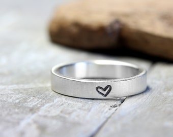 Band ring no. 05 made of 925 silver with an embossed heart, matt brushed