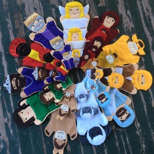 May include: A set of felt finger puppets depicting characters from the Nativity story. The puppets include a shepherd, a donkey, a sheep, a wise man, an angel, and Mary and Joseph.
