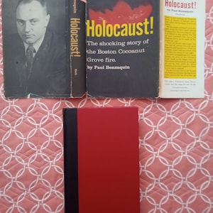 May include: A collection of books with the title "Holocaust!" visible on the covers. One book features a portrait of a man, while another displays the title in large yellow letters against a dark background. The books are arranged on a patterned surface.