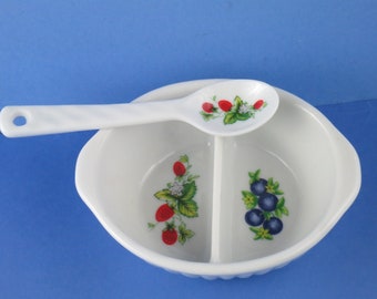 May include: A white divided ceramic bowl with a spoon. The bowl has a strawberry and blueberry design. The spoon has a strawberry design.