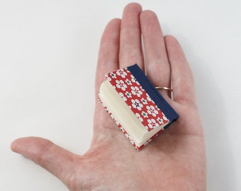 Hand-bound miniature sketchbook, covered with flowery Japanese origami paper cover. Red and blue!