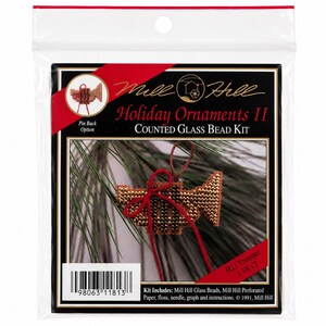 May include: Mill Hill Holiday Ornaments II Counted Glass Bead Kit featuring an H13 Trumpet design. The package includes materials to create a beaded trumpet ornament measuring 1 3/8 inches by 2 inches, with a red ribbon bow and a pin back option.