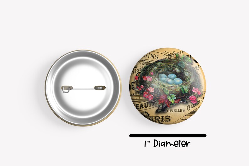 May include: A 1-inch diameter button featuring a vintage illustration of a bird's nest with blue eggs. The nest is surrounded by pink flowers and green leaves. The background is a faded, yellowed piece of paper with French text that reads "Beaut&eacute; de Paris" and "Nouvelles Galeries".