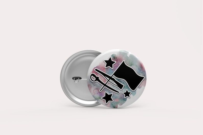 May include: A white button with a watercolor background in shades of pink, blue, and green. The button features a black silhouette of a color guard flag, two rifles crossed, and three stars.