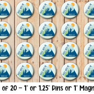 May include: A set of 20 round pins or magnets. Each pin features a design with the text "WALK WITH ME" and "MOSES 6:34". The design includes a mountain, figures, and a sun in shades of blue, green, and yellow. The pins are 1" or 1.25" in diameter.