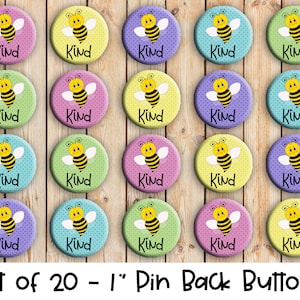 May include: Set of twenty 1-inch pin back buttons featuring a cartoon bee with the word "Kind" on each button. The buttons are in various colors, including yellow, green, blue, and purple.