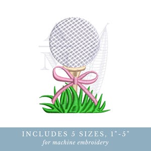 May include: A machine embroidery design featuring a white golf ball with a textured surface resting on a wooden tee. A pink ribbon is tied around the tee, and the base is surrounded by green grass. The text below states: INCLUDES 5 SIZES, 1"-5".