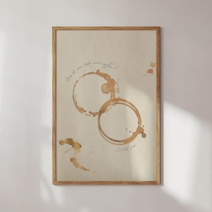 May include: A framed print with a beige background and brown coffee stains. The text "How do you take your coffee? With you." is written in black ink.