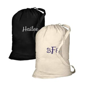 May include: Two laundry bags, one black with the name "Hailee" embroidered in white, and one beige with the initials "BF" embroidered in purple.