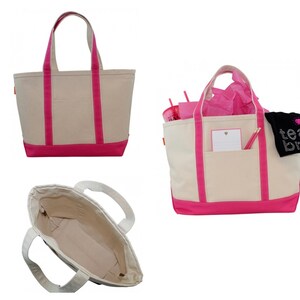 May include: A white canvas tote bag with pink trim and handles. The bag is shown in three different views: front, side, and inside. The inside view shows the bag is empty.
