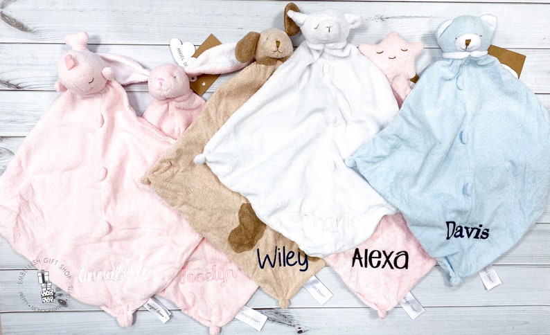 May include: Five personalized baby blankets with different animal characters. The blankets are in pink, brown, white, blue, and pink. The names "Madison", "Brooklyn", "Wiley", "Alexa", and "Davis" are embroidered on the blankets.