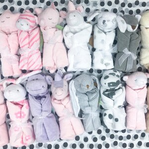 May include: A collection of 15 plush baby blankets, each featuring a different animal design. The blankets are rolled up and tied with a ribbon. The animals include a bunny, a unicorn, a dog, a cat, a hippo, a giraffe, a zebra, a cow, a pig, a duck, and a bear. The blankets are all in pastel colors, such as pink, blue, yellow, and green. The blankets are perfect for babies and toddlers.
