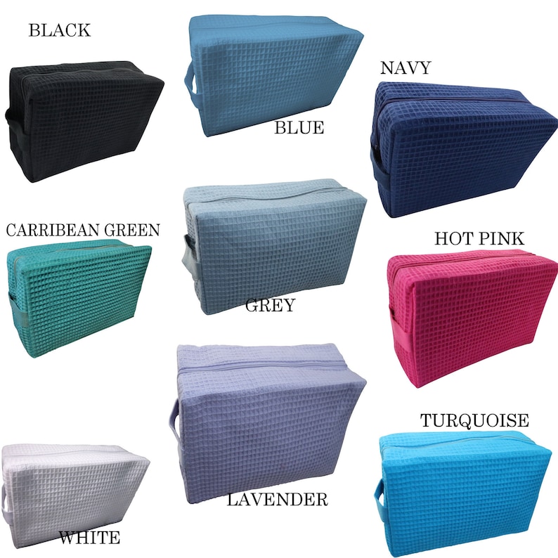 May include: A collection of rectangular cosmetic bags in various colors, including black, blue, navy, Caribbean green, grey, hot pink, white, lavender, and turquoise. Each bag features a waffle-weave texture, a zipper closure, and a handle.
