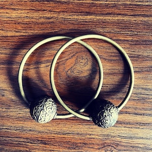 Huge brass earrings.