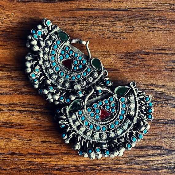 Pair of metal temporals with turquoise stones.