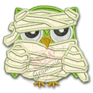 May include: A green and white mummy owl with large eyes. The owl is wrapped in white bandages and has a yellow beak.