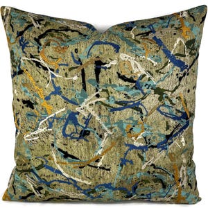 May include: A square throw pillow with a green background and abstract blue, yellow, and black paint splatter design.