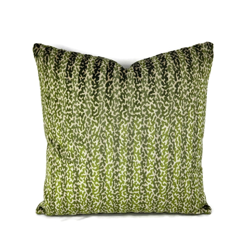 May include: Green and white striped throw pillow with a subtle animal print pattern.